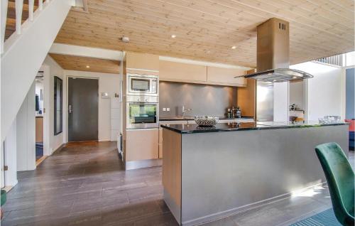 a large kitchen with a counter and a kitchen island at Holiday Home Mimosavej Ebeltoft Iii in Ebeltoft