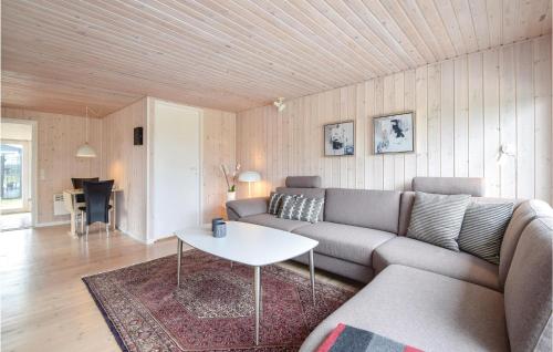 a living room with a couch and a table at Three-Bedroom Holiday Home In Juelsminde in Sønderby