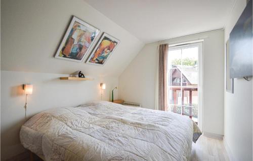 a white bedroom with a bed and a window at Amazing Home In Rm With House Sea View in Bolilmark