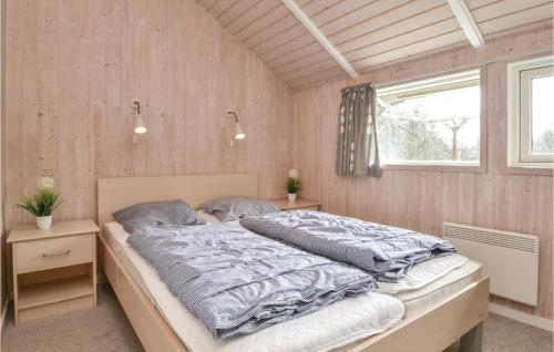 a bedroom with a large bed in a room at Beautiful Home In Fan With Kitchen in Fanø