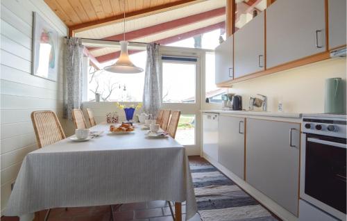 a kitchen with a table with a white table cloth at Two-Bedroom Holiday Home In Aabenraa in Aabenraa