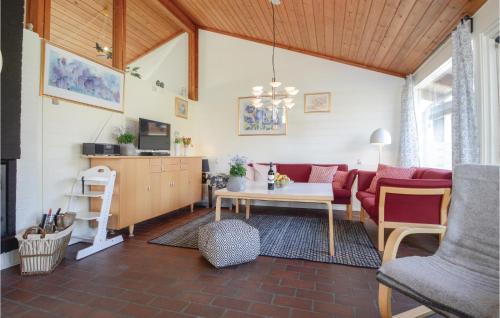 a living room with a red couch and a table at Two-Bedroom Holiday Home In Aabenraa in Aabenraa