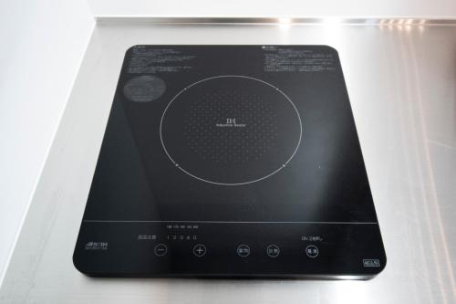 a tablet computer sitting on top of a refrigerator at UCHI Living Stay KCU in Sapporo