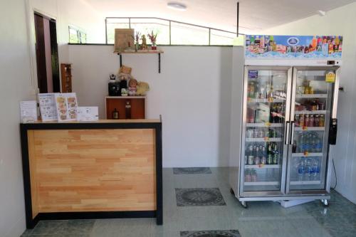 a room with a refrigerator and a counter at NK Garden Hotel @Suratthani Airport in Suratthani