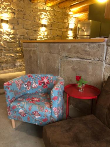 a blue chair sitting next to a red table at Solano de Moran in Murillo de Gállego