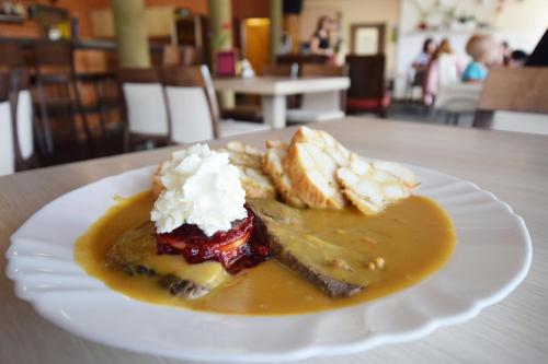 a white plate with a dessert on a table at Apartmán U Sikorek in Říčky
