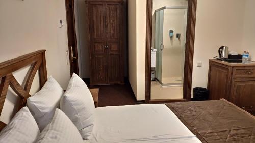 a bedroom with a bed and a walk in shower at Maajid Boutique Hotel in Baku