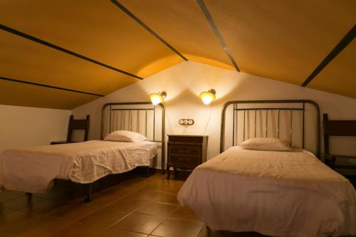 a bedroom with two beds in a room at La Troje Oropesana in Oropesa