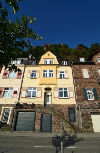 a large yellow building on the side of a street at Ferienhaus Maja in Cochem
