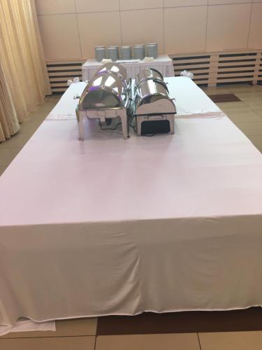 a large white table with chairs on top of it at Hotel Livade in Čačak