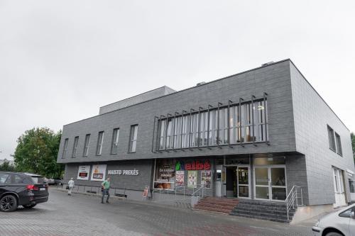 a building on a street with cars parked in front of it at Muontis in Šilalė