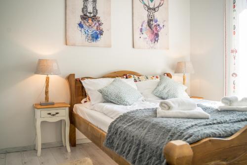 a bedroom with a bed with two towels on it at Apartamenty Na Szczycie z balkonem - Dream Apart in Szczyrk