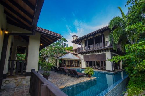 an image of a house with a swimming pool at Sergeant House Boutique Villa & Private Beach in Unawatuna