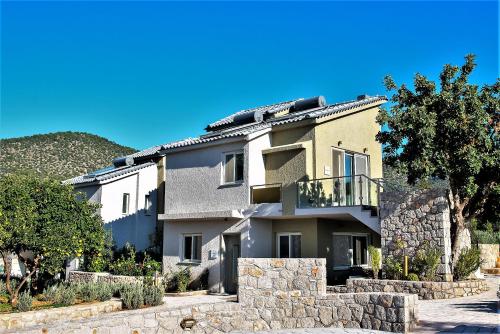 a large house with a stone wall at Lavender Cove in Korfos