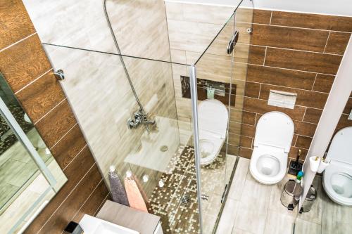 a bathroom with two toilets and a shower at Golden Beach in Šventoji