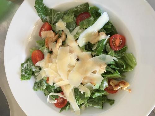 a white bowl filled with a salad with cheese and tomatoes at Penzión Petrov grunt in Košúty