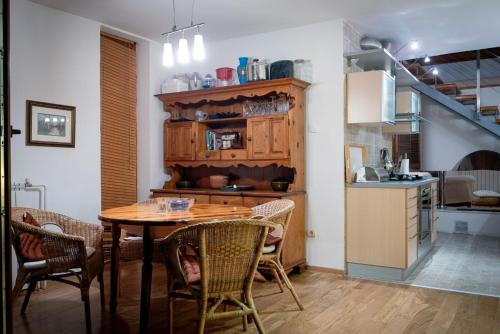 a kitchen and dining room with a table and chairs at Belegis Villa in Stari Banovci