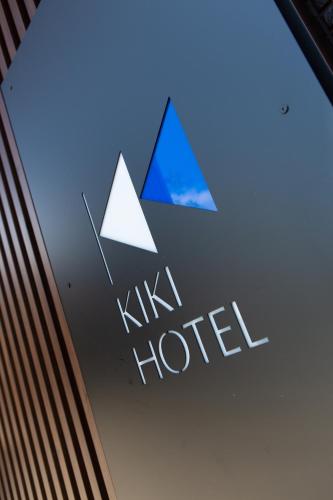 a sign for a hotel with two triangles on it at KIKI HOTEL in Kanazawa