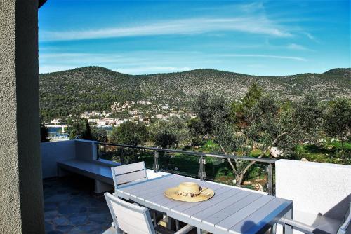 a table and chairs on a balcony with a view at Lavender Cove in Korfos