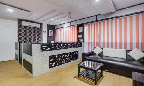 a living room with a couch and a table at Hotel Royal Dezire Udaipur in Udaipur