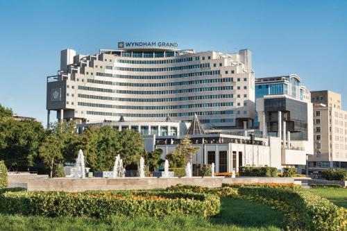 a large building with a sign on top of it at Wyndham Grand Kayseri in Kayseri
