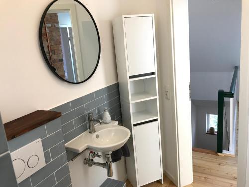 a bathroom with a sink and a mirror at Haus Schönkamp in Lübeck