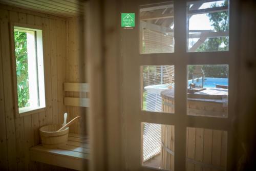 a window in a room with a view of a tub at Green Chalet in Veresegyház