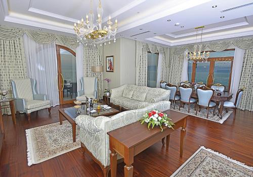 a living room with a couch and a table at Wellborn Luxury Hotel in Kocaeli