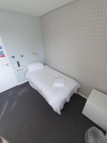a small room with a white bed in it at The Derby Conference Centre - Shared Accomodation in Derby