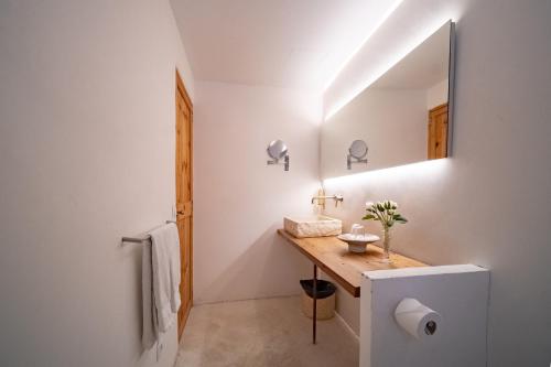 a bathroom with a sink and a mirror at Petit Hotel Forn Nou in Artá