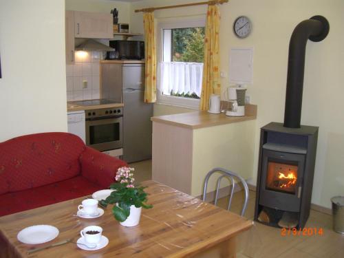 a living room with a wood stove in a kitchen at Canow in Canow