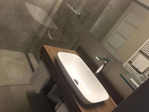 a bathroom with a white sink and a shower at LakeSide Apartments Seefeld in Seefeld in Tirol