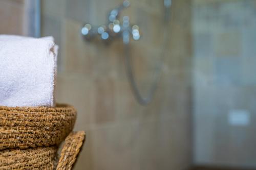a stack of towels in front of a shower at Borgo Castello Panicaglia in Nocera Umbra