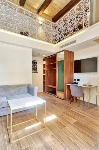 a living room with a couch and a table at 23 Boutique Hotel in Il-Furjana
