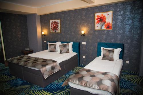a hotel room with two beds in it at Hotel Stefani in Sibiu
