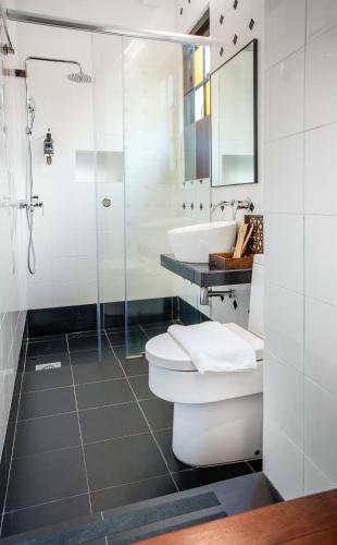 a bathroom with a toilet and a sink and a shower at Areca Hotel Penang in George Town