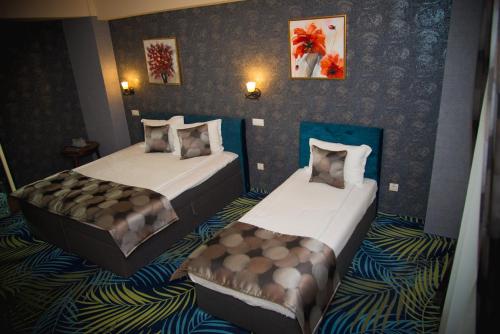 a hotel room with two beds in it at Hotel Stefani in Sibiu