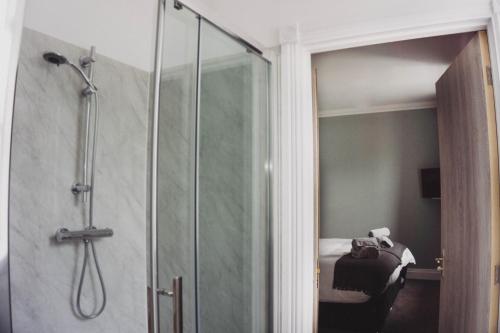 a shower with a glass door in a bathroom at THE BRUCE in Bowmore
