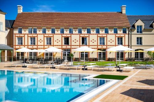 a hotel room with a pool and a large building at Staycity Aparthotels Paris Marne La Vallée in Bailly-Romainvilliers