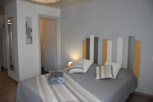 a bedroom with a bed with two pillows at Domaine de calbiac in Dolmayrac