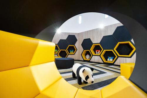 a room with a panda bear laying on the floor at Staycity Aparthotels near Disneyland Paris in Bailly-Romainvilliers