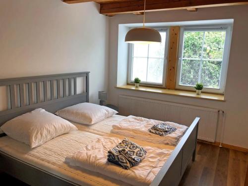 a large bed with two pillows on it in a bedroom at Schöne Ferienwohnung 120qm 4+2 Pers. in Fehmarn