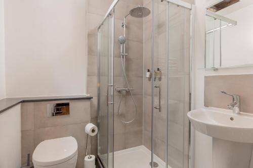 a bathroom with a shower and a toilet and a sink at Destiny Scotland Hanover Apartments in Edinburgh