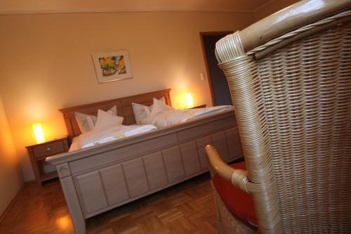 a bedroom with a large bed with white pillows at Weingut Schilling in Seinsheim