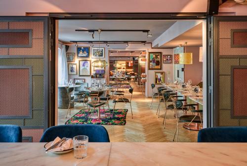 - un restaurant avec des tables et des chaises dans une salle dans l'établissement 25hours Hotel Terminus Nord, à Paris