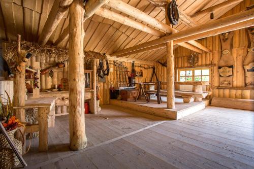a large room with wooden walls and wooden floors at Hotel Smile Pieniny in Szczawnica
