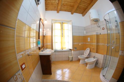 a bathroom with two toilets and a sink and a shower at Casa Lissania in Lamezia Terme
