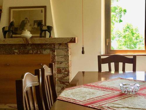 a dining room with a table and a fireplace at La Terrazza di Filomena - Picinisco, Parco Lazio & Abruzzo in Picinisco