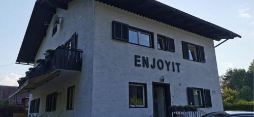 a white building with the words endowment on it at Enjoyit Velden West in Selpritsch