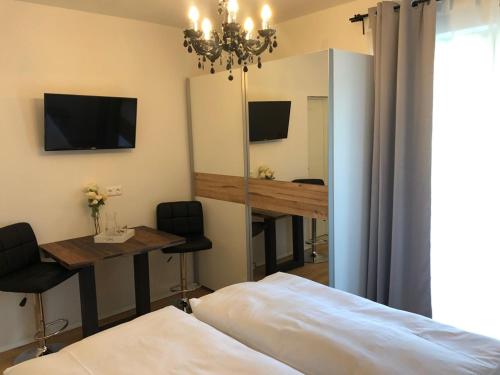 a bedroom with a bed and a table and a mirror at Enjoyit Velden West in Selpritsch